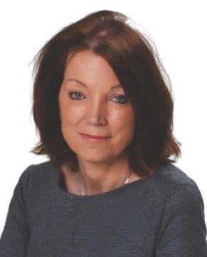 Headshot of a woman with brown hair, wearing a grey top and a subtle smile.